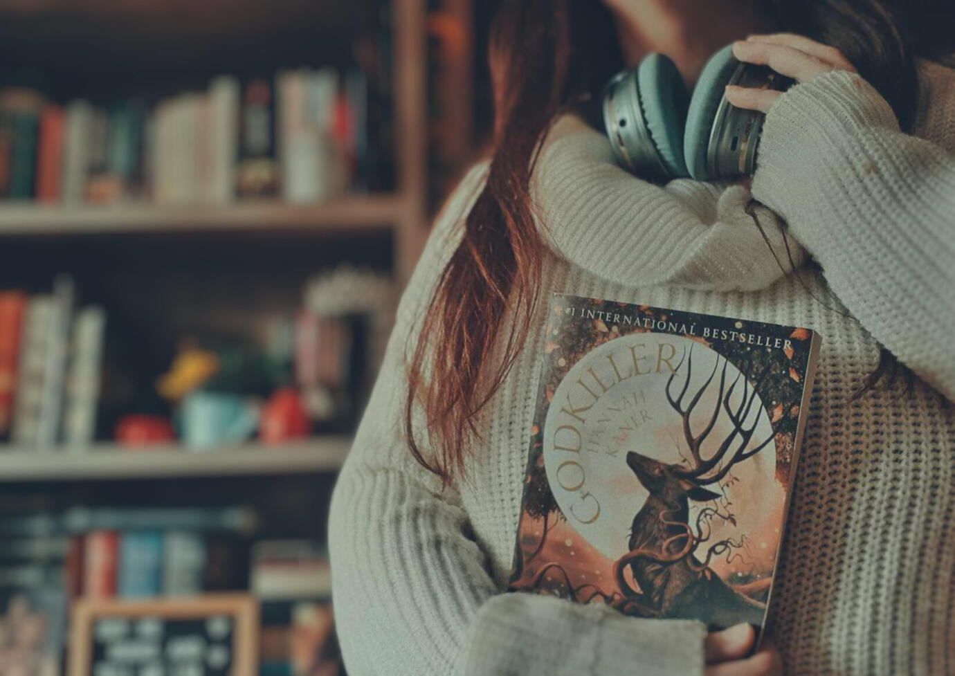 Picture of Donna holding a stack of 7 books